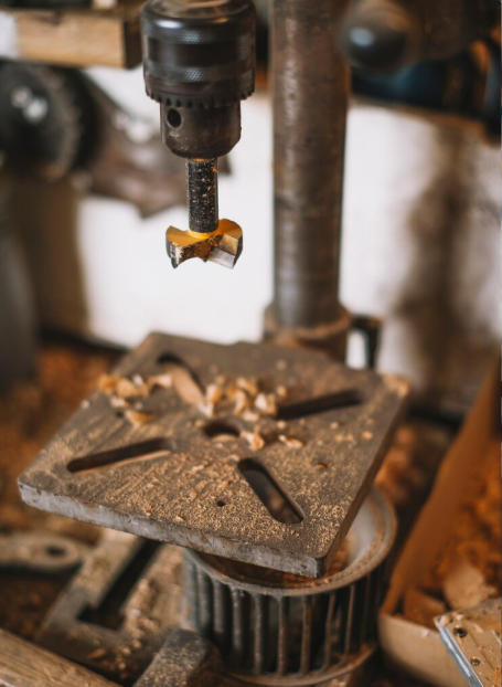 Precision metal drilling operation in manufacturing facility
